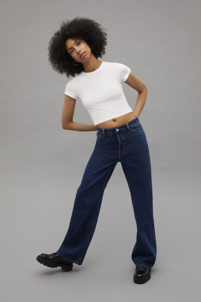 Model wearing a pair of jeans that are fit for a circular economy. These jeans should be used more, made to be made again, and made from safe and recycled or renewable inputs.